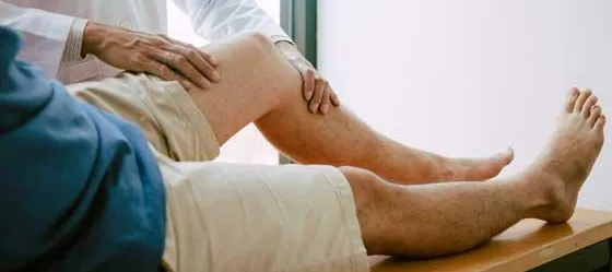 Decorative only image - person receiving knee exam