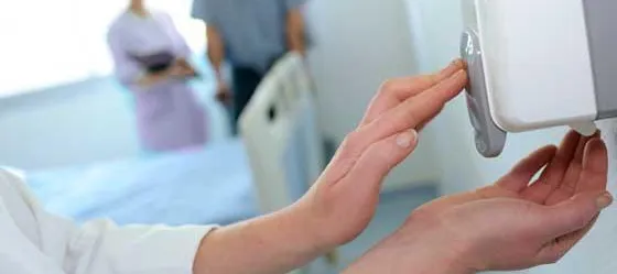 Decorative only image - person using hand sanitizer pump