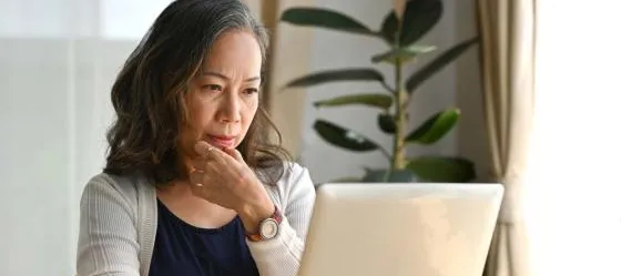 Decorative only image - woman looking at laptop
