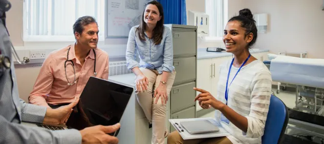 Decorative only image - group of health professionals sit in circle having a conversation