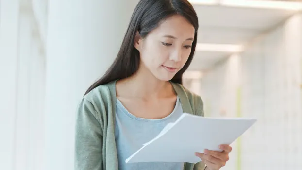 Decorative only image - woman looking at piece of paper